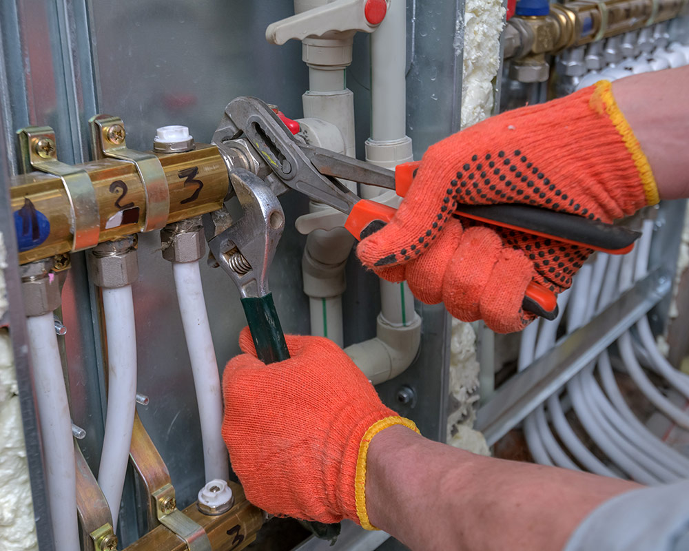 technician hands close up with tools replacing heating system pumps plantation fl